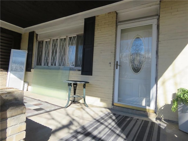 property entrance with brick siding