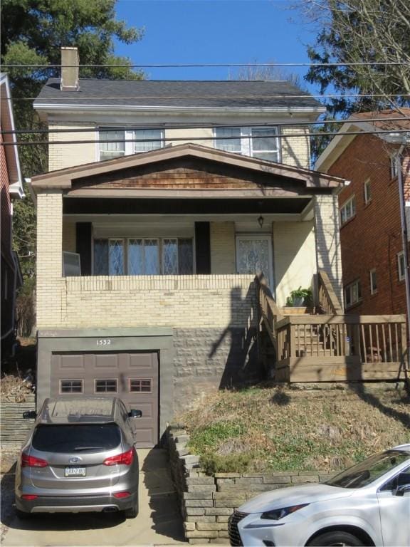 view of front of home with concrete driveway, brick siding, and an attached garage