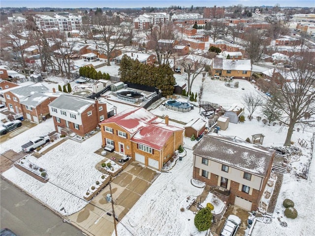 snowy aerial view with a residential view