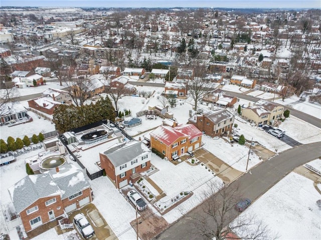 snowy aerial view featuring a residential view