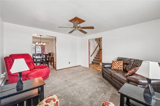 carpeted living area featuring stairs, baseboards, and ceiling fan with notable chandelier