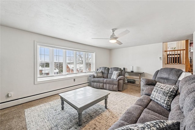 living room with ceiling fan, a textured ceiling, and a baseboard radiator