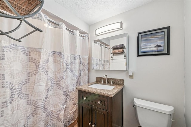 bathroom with a textured ceiling, vanity, toilet, and a shower with curtain