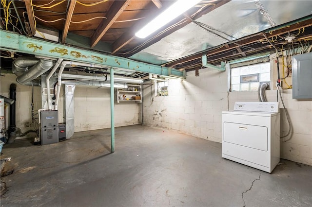 basement with heating unit, washer / dryer, and electric panel