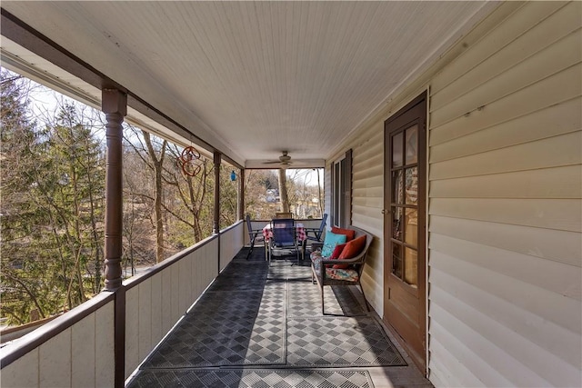 exterior space with a porch and a ceiling fan