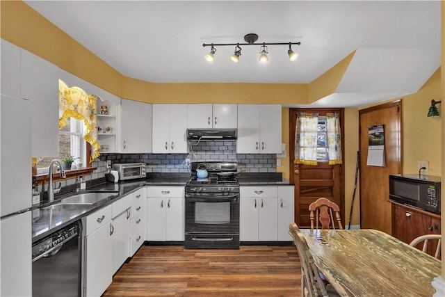 kitchen with open shelves, tasteful backsplash, a sink, under cabinet range hood, and black appliances