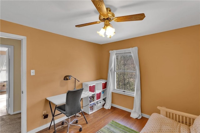 home office featuring baseboards, a ceiling fan, and wood finished floors