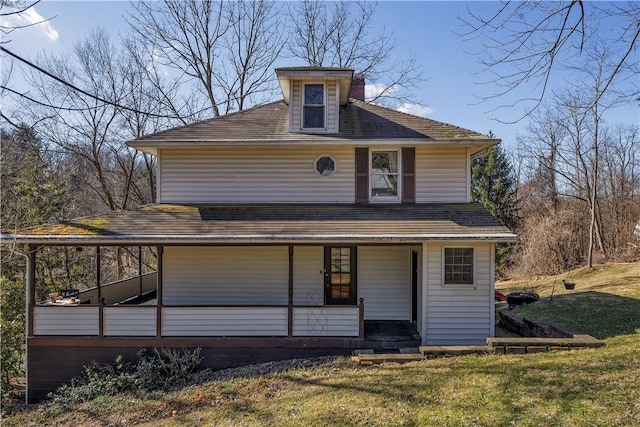 view of front facade with covered porch and a front yard