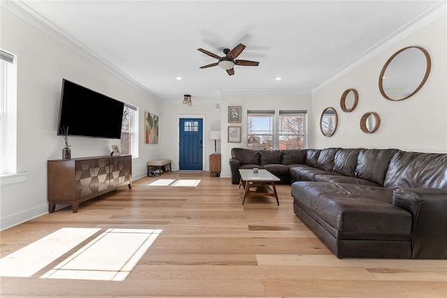 living room featuring light wood finished floors, baseboards, and ornamental molding