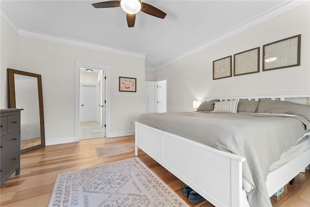 bedroom with a ceiling fan, wood finished floors, baseboards, and ornamental molding