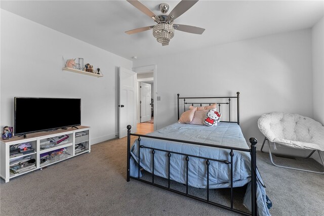 carpeted bedroom with baseboards and ceiling fan