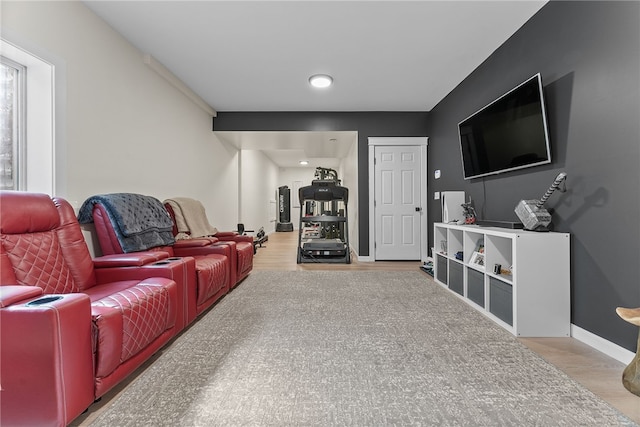 home theater with wood finished floors and baseboards