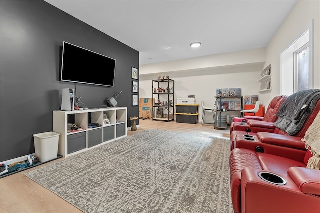 living area with baseboards and wood finished floors