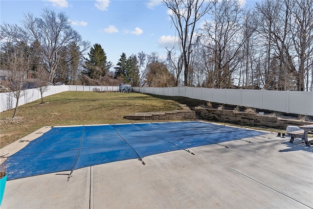 view of pool with a patio, a yard, a fenced backyard, and a fenced in pool