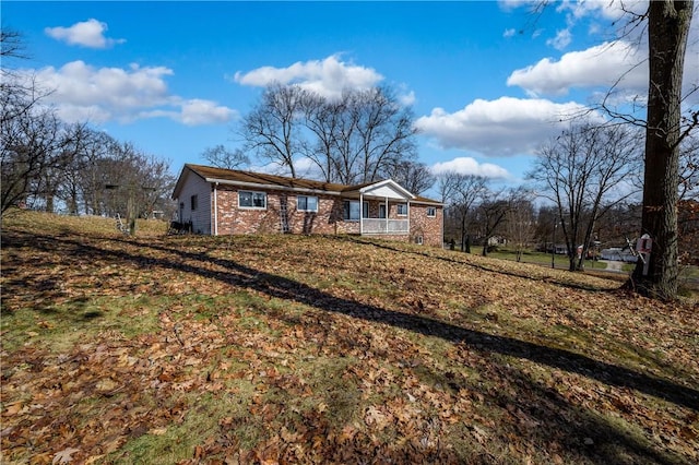 single story home featuring brick siding