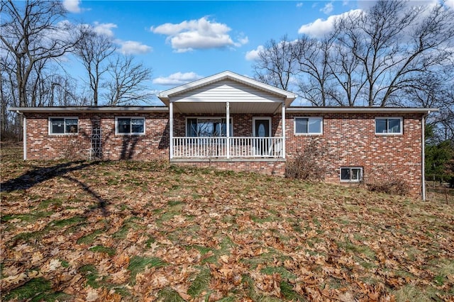 view of front of property with brick siding and a porch