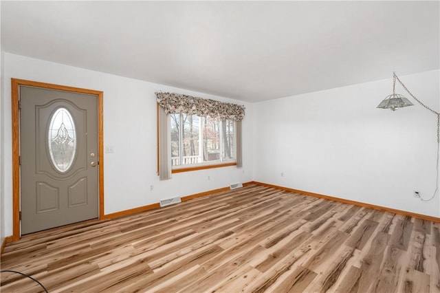 entryway featuring light wood-type flooring, visible vents, and baseboards