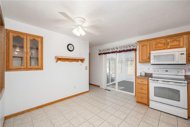 kitchen featuring white appliances, baseboards, a ceiling fan, glass insert cabinets, and brown cabinets