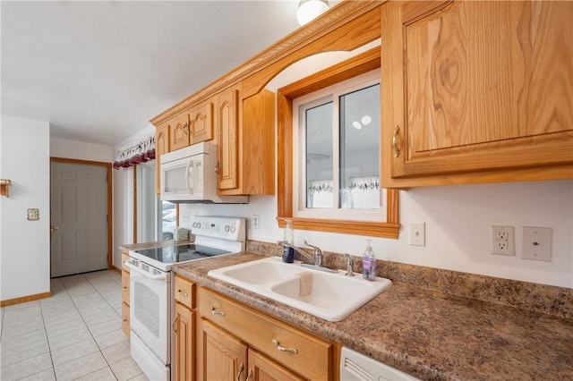 kitchen with white appliances, light tile patterned flooring, a sink, and baseboards