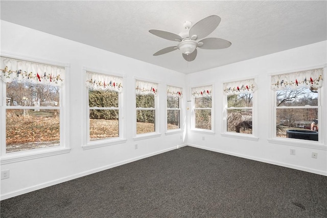 unfurnished sunroom with plenty of natural light and ceiling fan