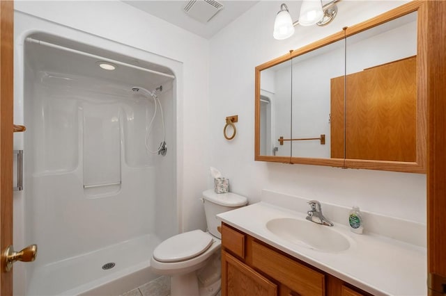 bathroom with toilet, visible vents, a shower, and vanity