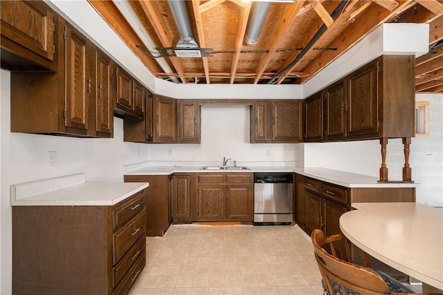 kitchen featuring dishwasher, light countertops, dark brown cabinets, and a sink