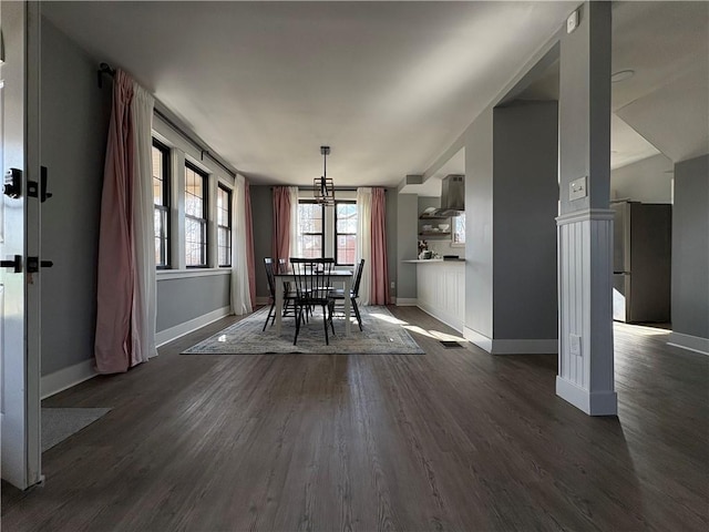 unfurnished dining area featuring visible vents, baseboards, and dark wood finished floors