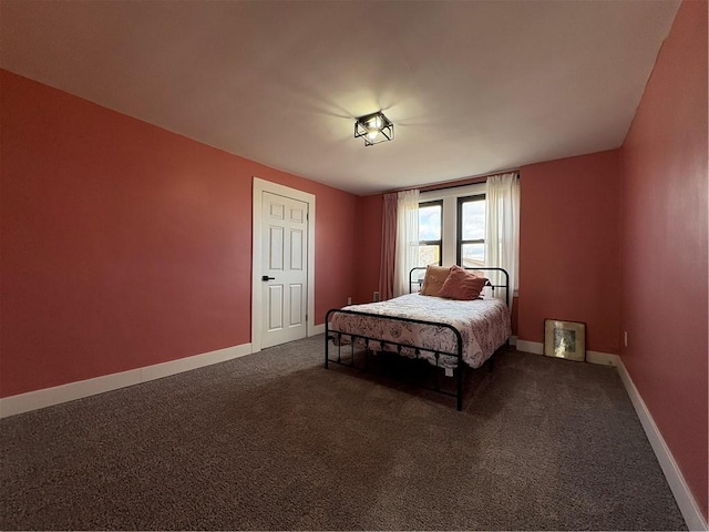 carpeted bedroom featuring baseboards