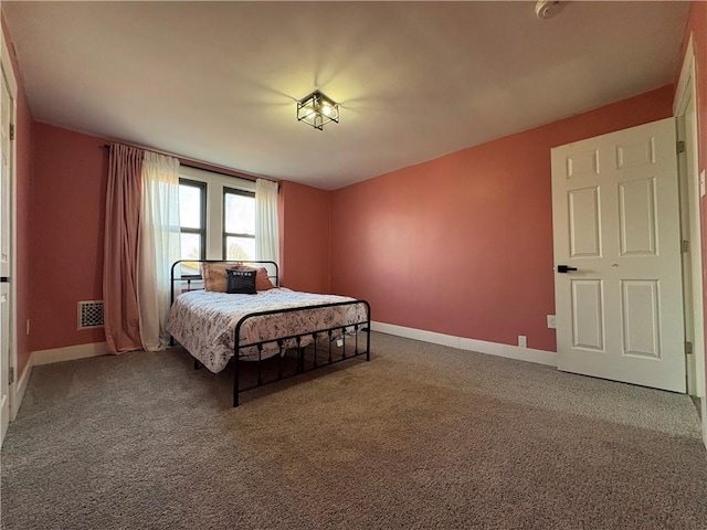 carpeted bedroom featuring visible vents and baseboards