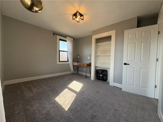 interior space featuring baseboards and carpet