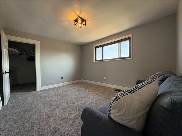 sitting room with baseboards and carpet floors