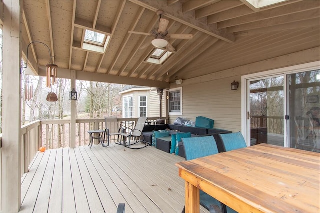 wooden terrace featuring ceiling fan, outdoor lounge area, and outdoor dining space