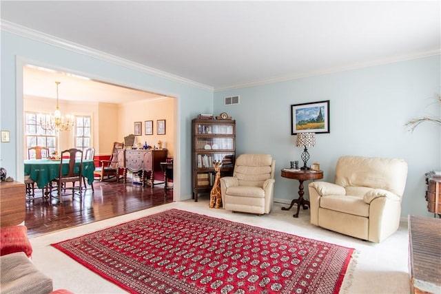 living area with ornamental molding, visible vents, and an inviting chandelier