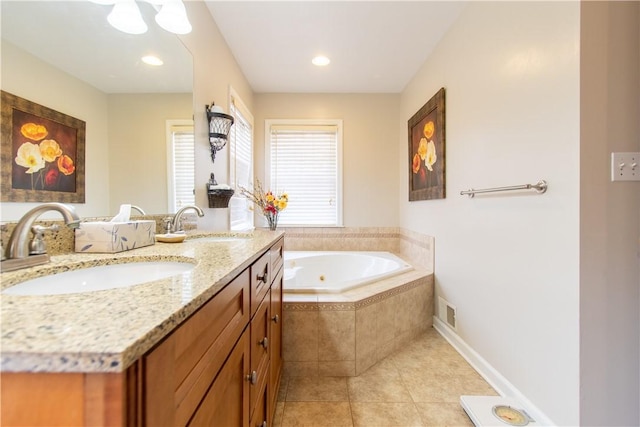 bathroom with double vanity, a sink, a bath, and tile patterned floors