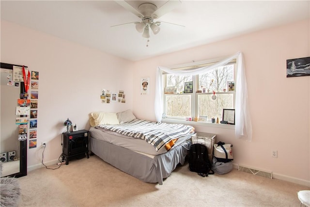 bedroom featuring ceiling fan, carpet flooring, visible vents, and baseboards