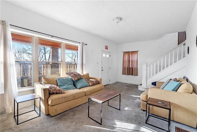 living area with stairs, carpet, and baseboards