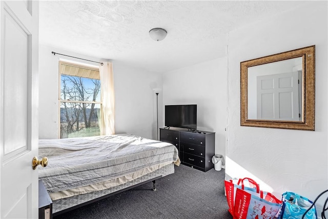 carpeted bedroom featuring a textured ceiling