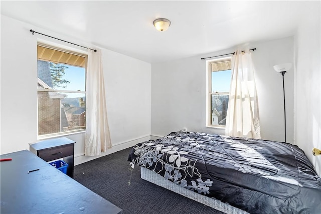 bedroom with multiple windows and baseboards