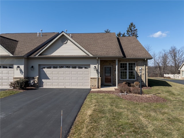 ranch-style house featuring aphalt driveway, brick siding, a shingled roof, an attached garage, and a front lawn