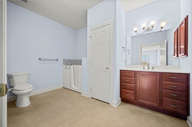 full bathroom featuring toilet, an inviting chandelier, vanity, baseboards, and tile patterned floors