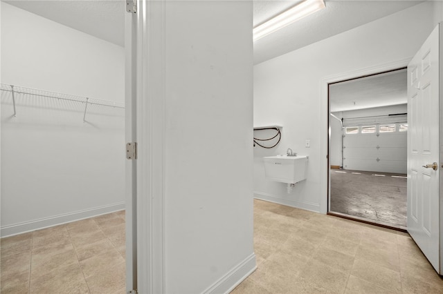 bathroom featuring baseboards and a sink