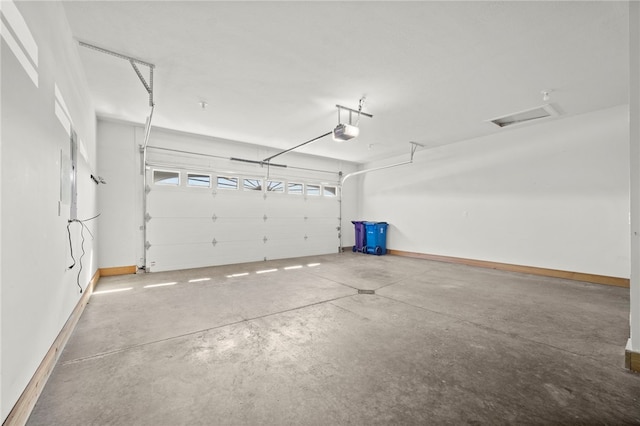 garage featuring baseboards and a garage door opener