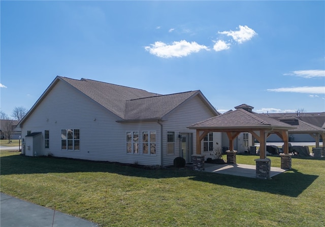 rear view of house featuring a patio, a gazebo, and a lawn