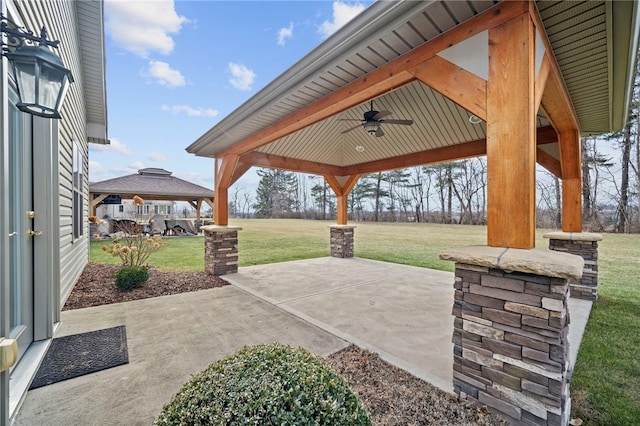 view of patio with ceiling fan and a gazebo