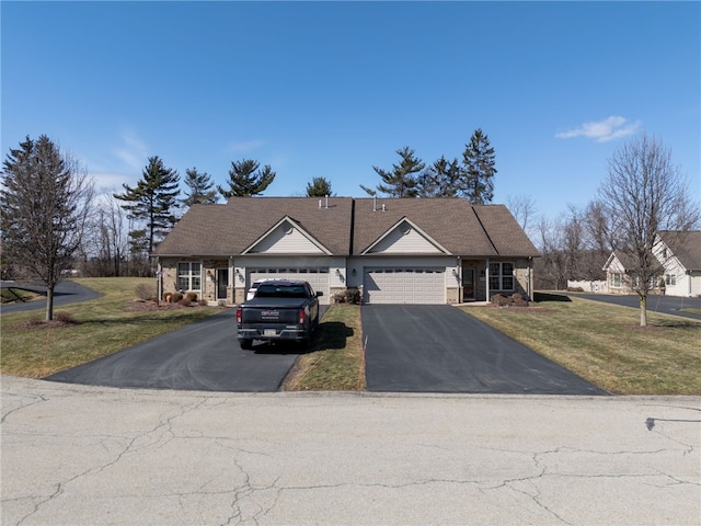 view of front of house featuring driveway, stone siding, and a front yard