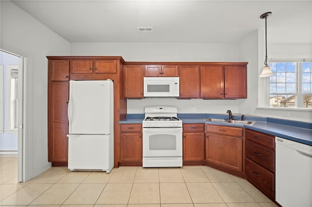 kitchen with white appliances, light tile patterned floors, visible vents, decorative light fixtures, and a sink