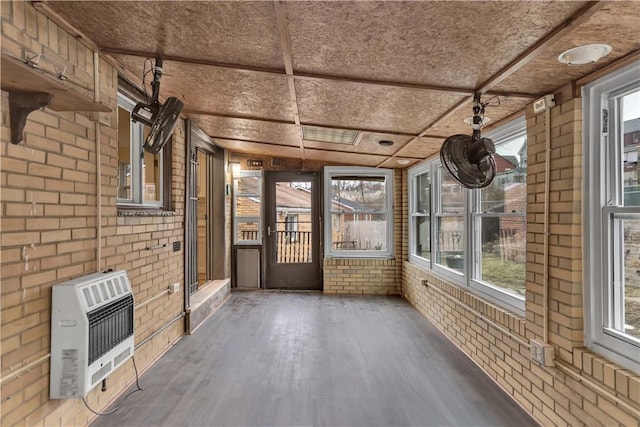 unfurnished sunroom featuring heating unit