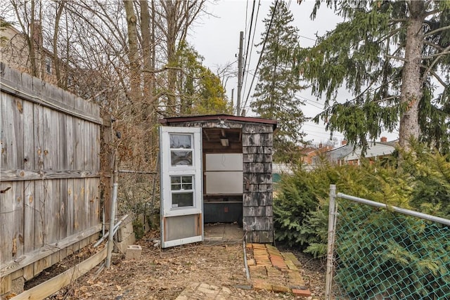 view of outdoor structure with an outbuilding and fence