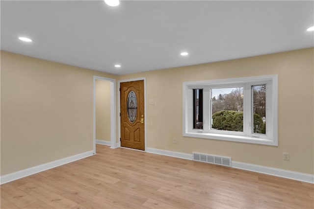 entryway with recessed lighting, visible vents, light wood finished floors, and baseboards