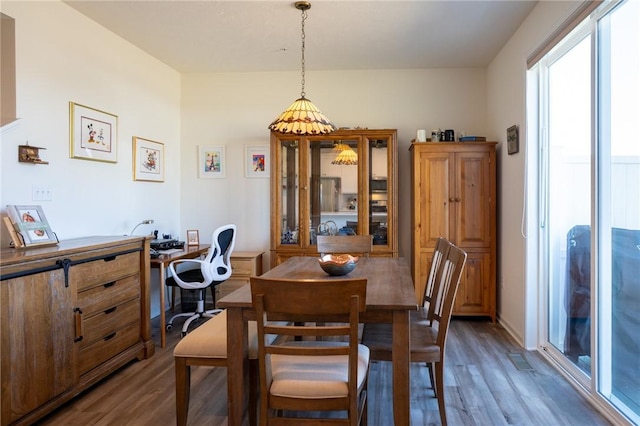 dining area featuring dark wood-style flooring